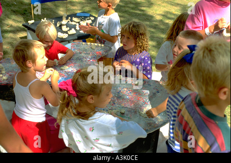 Kids age 5 working on 4H clay art project at Minnesota State Fair. St Paul Minnesota USA Stock Photo