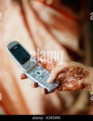 South Indian woman text messaging on a mobile phone Stock Photo - Alamy