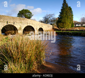 Village of Postbridge Dartmoor showing newer stone road bridge crossing East Dart river flowing beneath Stock Photo