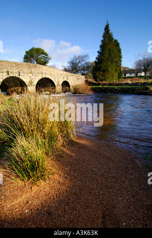 Village of Postbridge Dartmoor showing newer stone road bridge crossing East Dart river flowing beneath Stock Photo