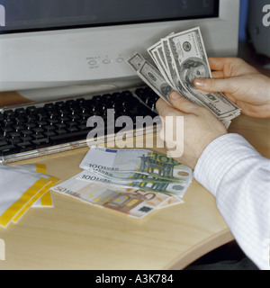 Back office cashier counting out banknotes Stock Photo