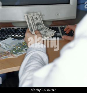Back office cashier counting out banknotes Stock Photo