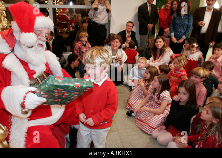 Miami Florida,office Christmas party,Santa Claus,child,children,presents,parents,employee employees worker workers working staff,FL051231175 Stock Photo