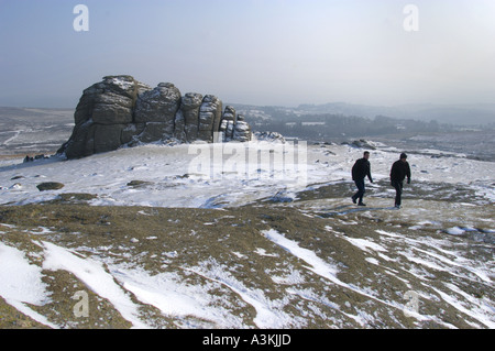 Walker on Haytor in Dartmoor National Park with a light covering of Snow Devon England Stock Photo