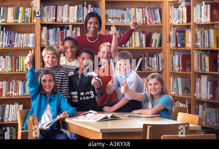Portrait of librarian and students in middle school library Stock Photo