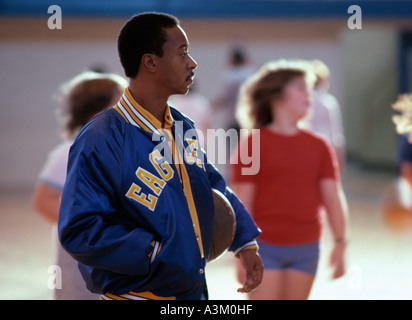 African American physical education teach in gym Stock Photo