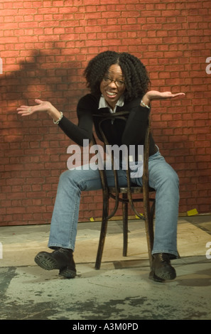 Portrait African American woman sitting on chair Stock Photo