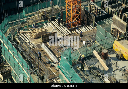 Semi aerial looking down on office block construction site with workers Stock Photo