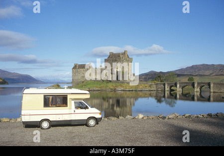 VW Volkswagen RV Auto Sleeper camper van motorhome early morning beside Scottish Eilean Donan Castle & reflections on Loch Duich Highlands Scotland UK