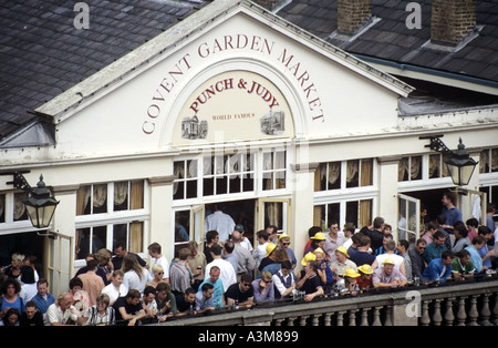 Covent Garden Market Punch & Judy pub close up view of crowd seen from above looking down on people drinking outside world famous balcony London UK Stock Photo