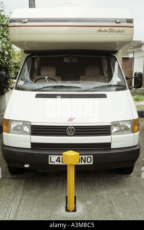 Key operated removable heavy steel security bollard concreted into domestic driveway help reduce theft of VW Auto Sleepers motorhome Essex England UK Stock Photo