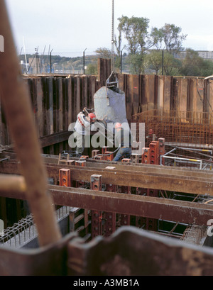 Workmen pouring concrete during the construction of a sewage pumping station, South Shields, Tyneside, Tyne and Wear, England UK Stock Photo