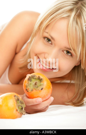 Woman holding persimmon