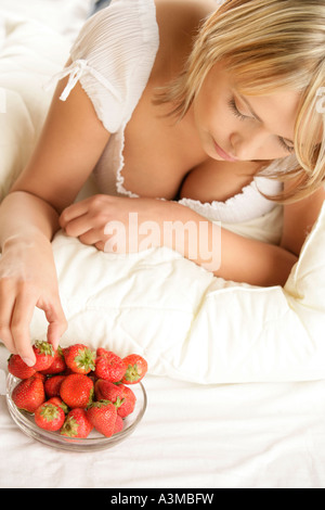 Young woman eating strawberries Stock Photo