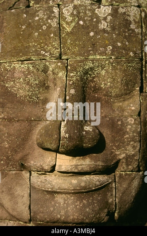 The smile of Angkor. Sculpted from stone, the smiling faces at Bayon temple are a symbol of Angkor, near Siem Reap, Cambodia. Stock Photo