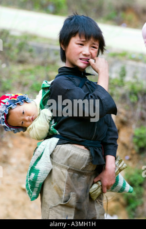 Young boy Hmong carry his sister of the Sapa area Stock Photo