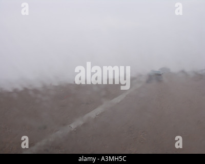 Heavy rain falling on car windscreen Stock Photo