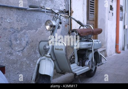 An old fashioned twin seater Lambretta motor bike in a back street in  Syracuse in Sicily Stock Photo - Alamy