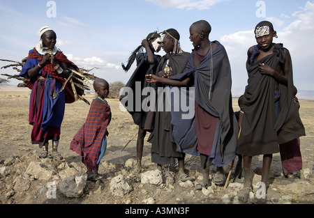 Young recently circumcised Masai Warrior and Masai girl in the Serengei Plains Tanzania Stock Photo