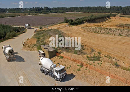 Trucks arriving at batching processing plant to collect cement Stock Photo