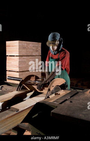 Edge cutting of Odum wood flooring blocks, Ghana, West Africa Stock Photo