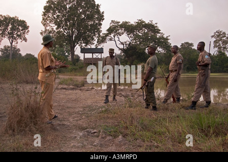 Park patrol team discussing patrol duties in Mole National Wildlife Park, Ghana, West Africa Stock Photo