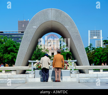 The A Bomb Memorial with the A Bomb Dome behind close to the epicentre of the Hiroshima atomic bomb Hiroshima Japan Stock Photo