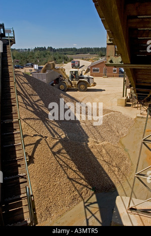 Loading gravel into truck from stockpile at quarry for construction purposes Stock Photo