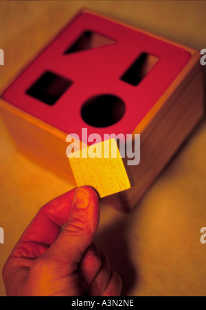 Square Peg In A Round Hole Stock Photo