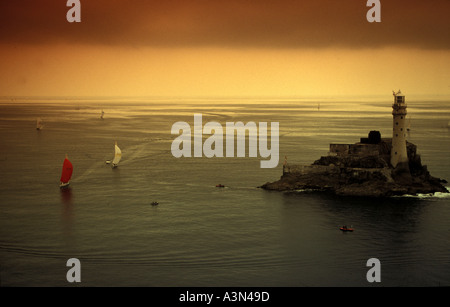 Two racing yachts approach the Fastnet rock at dawn Stock Photo