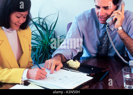 New York City NYC lawyer With secretary discussing a case on the telephone USA Stock Photo