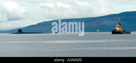 British Royal Navy Vanguard Class Submarine and Escorting Heavy Tug Impulse in the Firth of Clyde near Gourock Renfrew Scotland Stock Photo