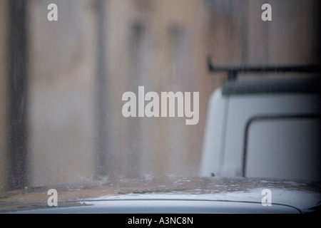 heavy rain falling on car roof Stock Photo