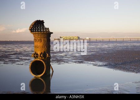 'LIVERPOOL FLEETWOOD TIDAL STANDARD'  Cast iron sewage outfall pipe Southport beach and pier, Merseyside, UK. Stock Photo