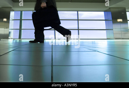 Man Walking Through Airport With Briefcase, Low Angle View New York, NY USA Stock Photo