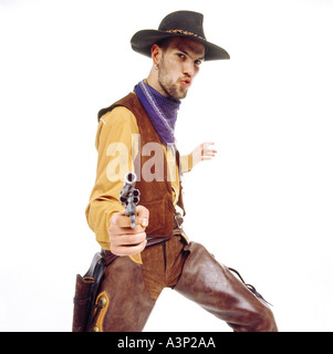 Young man dressed as cowboy, pointing gun, portrait Stock Photo