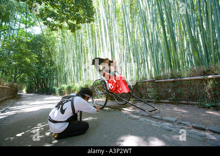 Two young women sitting in rickshaw in Sagano, Kyoto, Japan Stock Photo