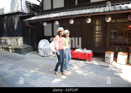 Two young women walking in old town Stock Photo