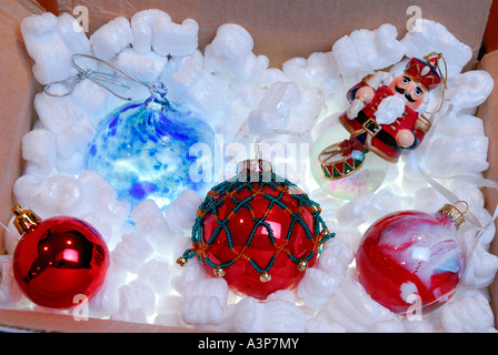 Christmas tree ornaments in a box of backlit styrofoam Stock Photo