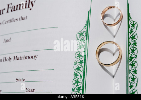 Two rings on a family album spine forming heart shaped shadows Stock Photo