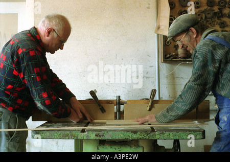 Two elderly carpenters at work, Poland Stock Photo