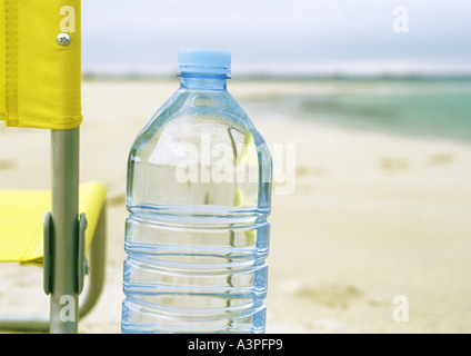 Bottle of water on beach Stock Photo