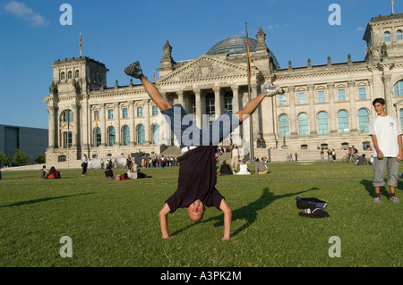 Young man doing handstand in front of German Parliament Building in Berlin, Germany Stock Photo
