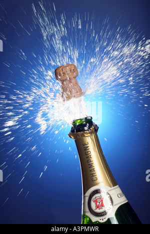 Cork shooting out of a champagne bottle Stock Photo
