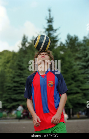 Young man holding a soccer ball on his head, Kaliningrad, Russia Stock Photo