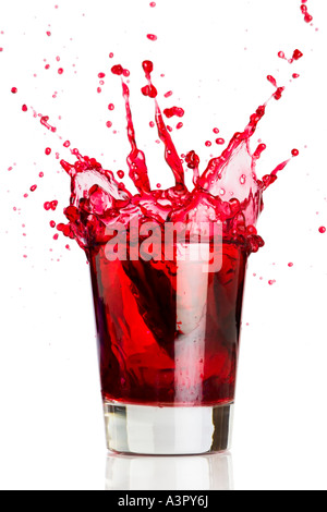 Ice cube dropped into a glass of grape juice Stock Photo