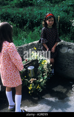 May Garland of flowers carried around in Bampton Oxfordshire on Mayday by two young girls 1970s UK HOMER SYKES Stock Photo