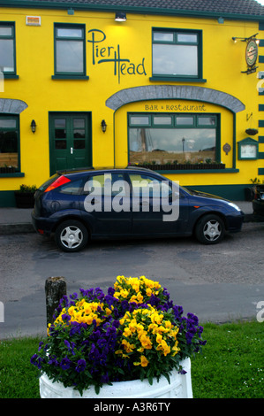 Dock area in Kinvara Ireland flowers brighten the pavement Stock Photo