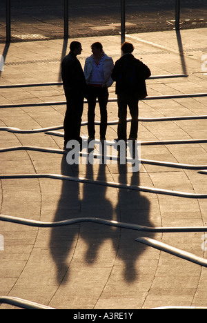 Three people in Millennium Place, Coventry, West Midlands, England, UK Stock Photo