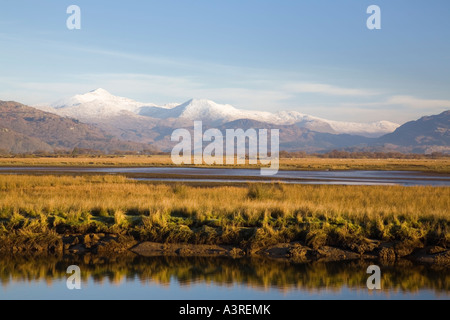 Afon Glaslyn River and Glaslyn Marshes Site of Special Scientific Interest with snow on mountains. Porthmadog Gwynedd Wales UK Stock Photo